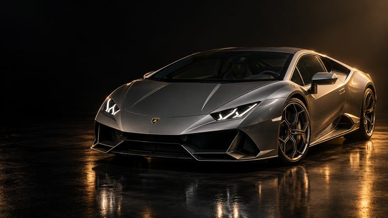 A grey Lamborghini Huracán EVO on a dark studio floor