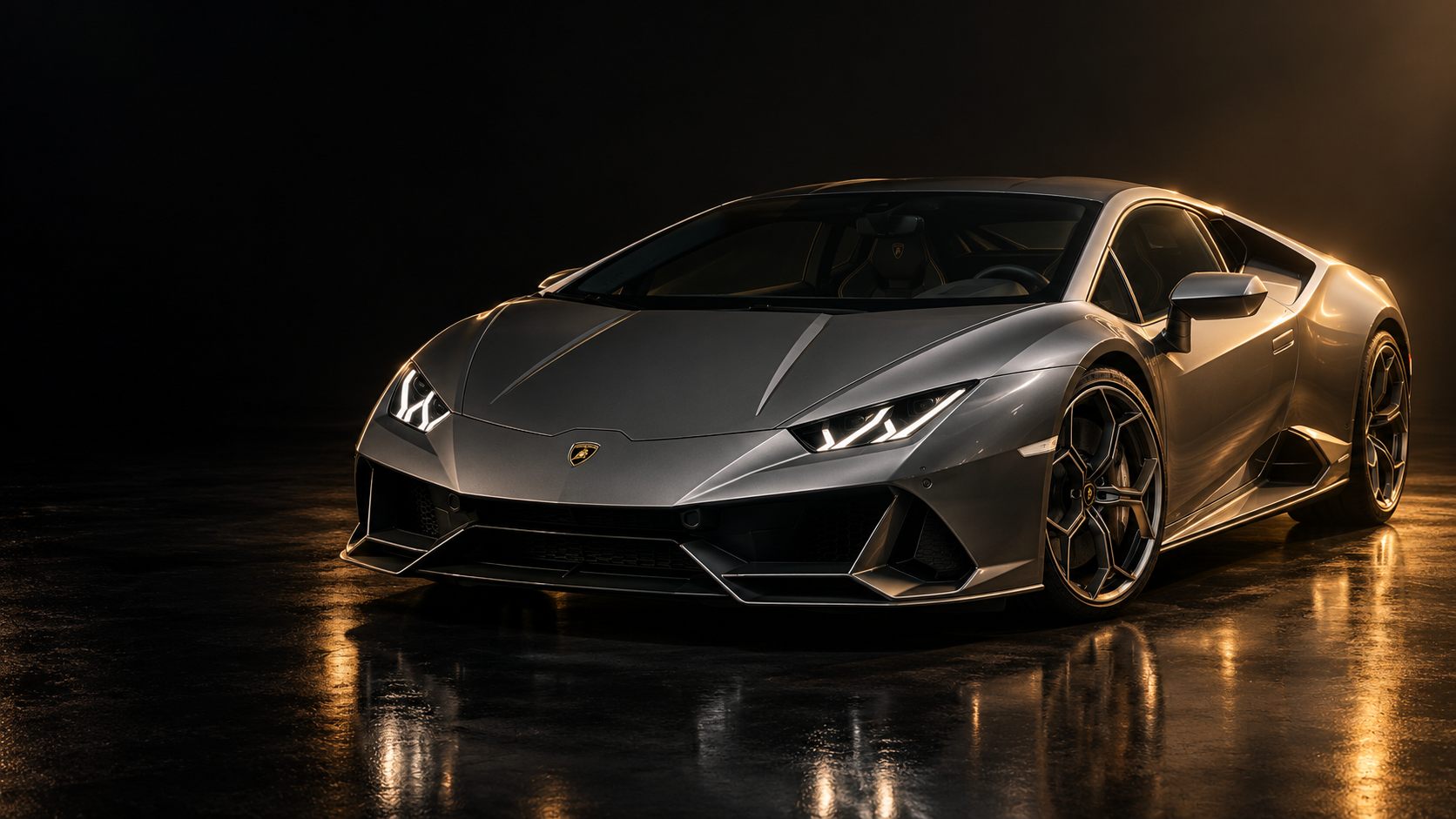 A grey Lamborghini Huracán EVO on a dark studio floor